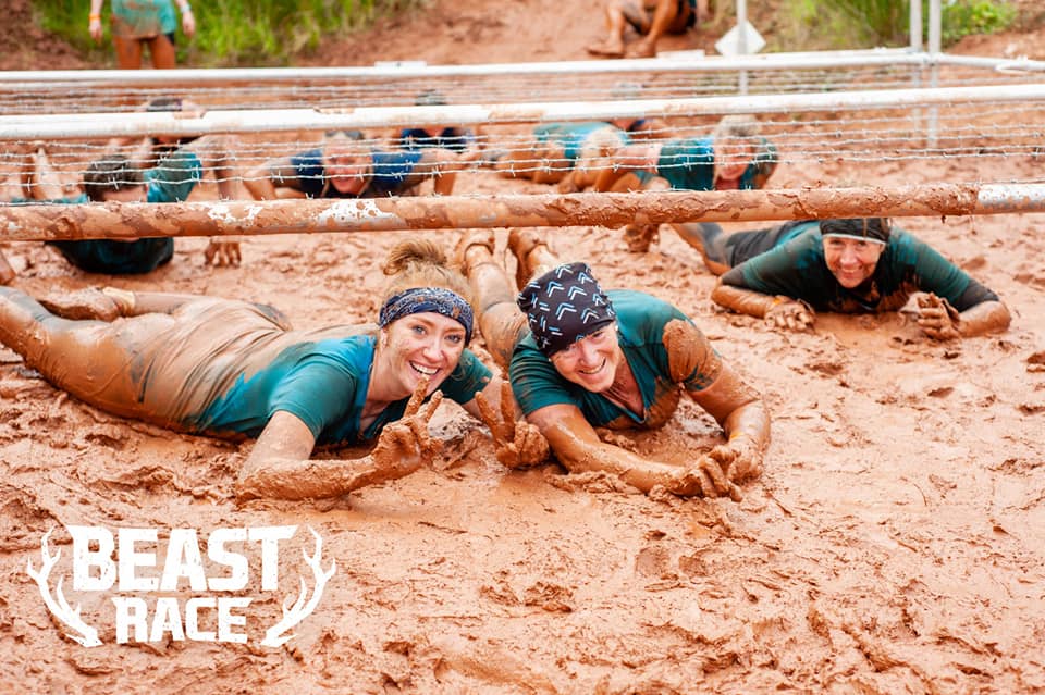 Participants in the mud run obstacle course